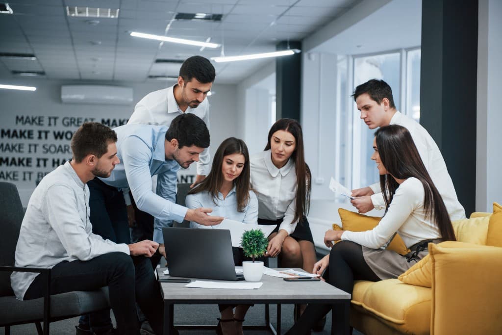 Diverse professionals collaborating around documents in a modern office